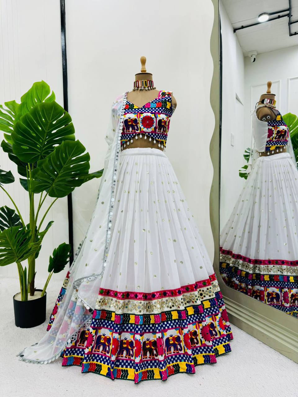 Exquisite Pristine White Designer Lehenga Choli with Vibrant Multicolored Traditional Elephant Embroidery and Mirror Work Detailing